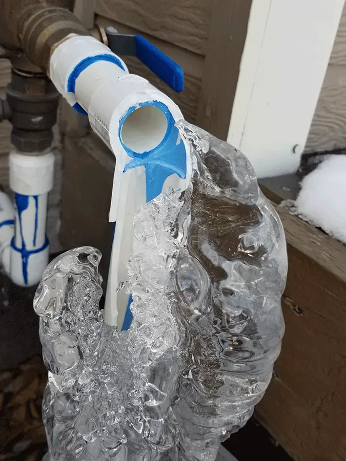 Frozen pipe split behind a garage wall in Maple Grove, MN